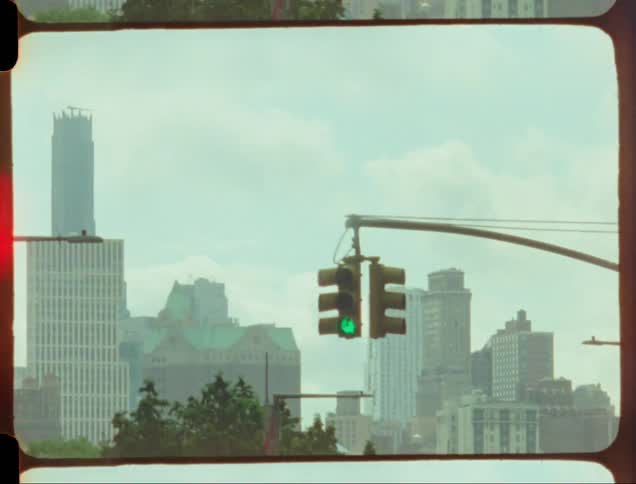 Car passes over an overpass near a downtown intersection on a hazy day