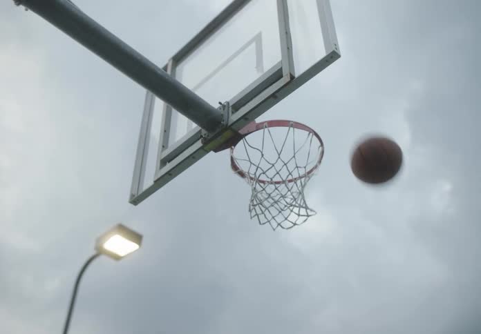 Basketball ball being thrown towards the basket and falling out
