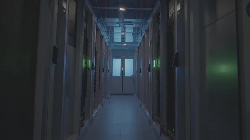 Narrow hallway of a database with lights turning on