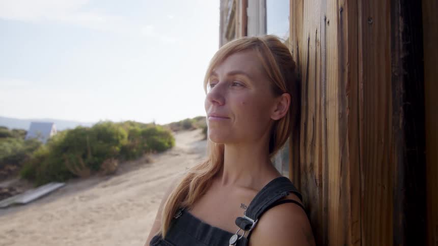 Portrait of a young blonde woman enjoying nature and with happy facial expression