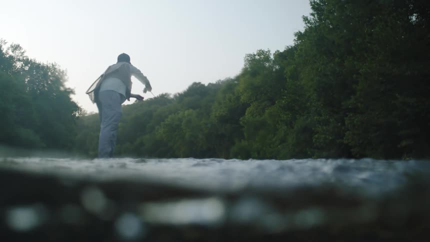 Man with a rod fishing in a river
