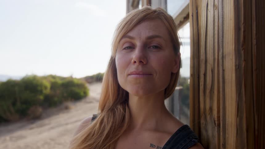 Blonde woman turning her face with happy facial expression