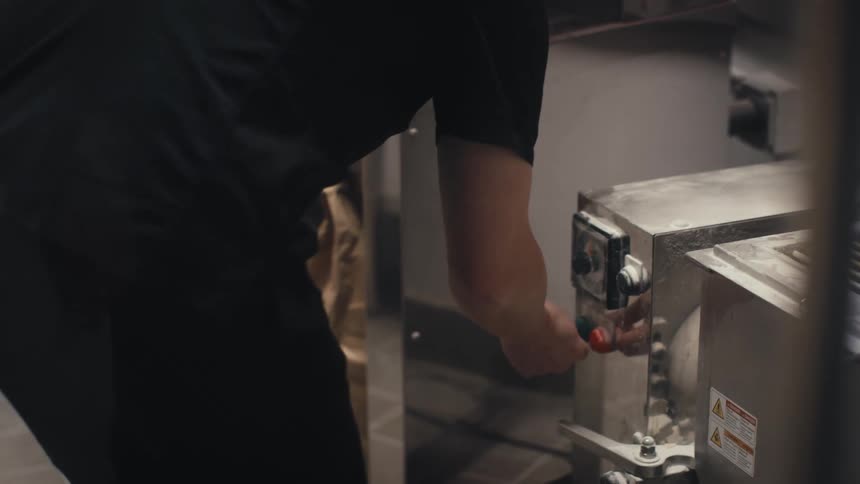 A man turning on a large machine