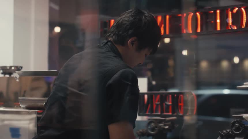 A restaurant kitchen worker emptying a bowl of flour