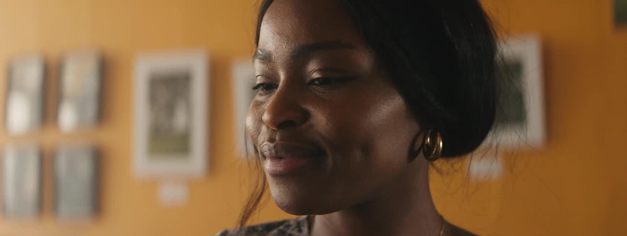 A woman blinks and smiles widely