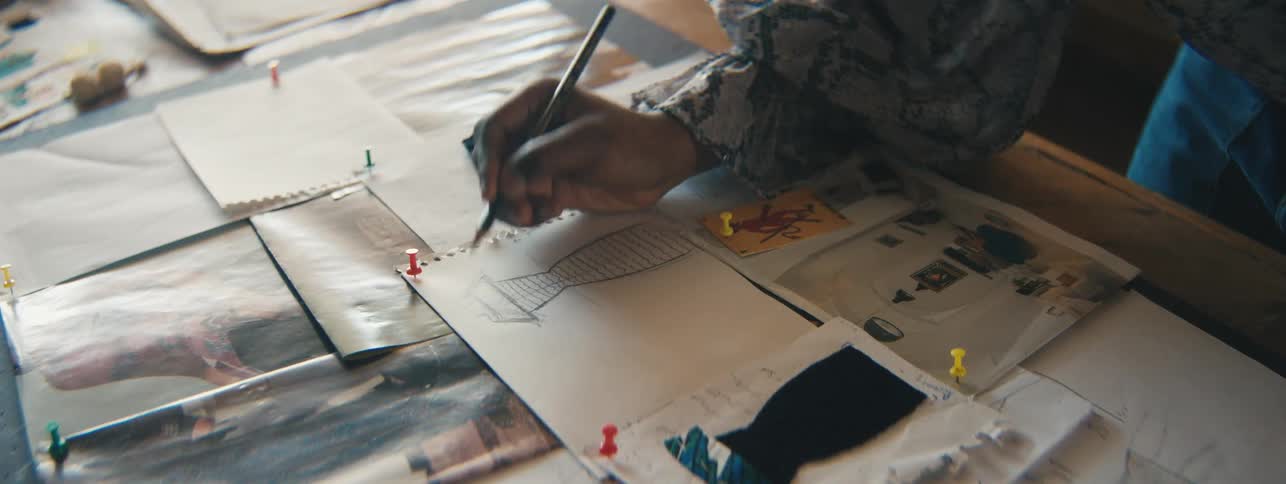 Hand of an illustrator drawing a dress