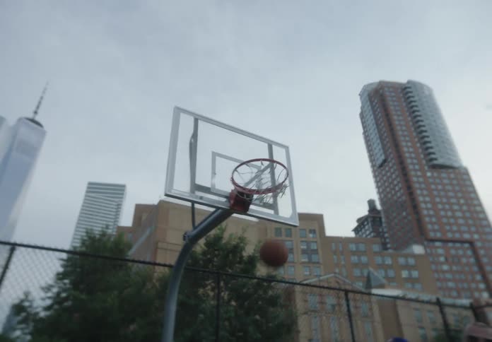 A man hits a basket while playing basketball