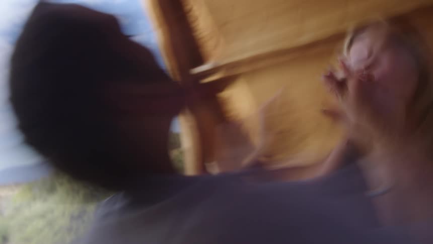 Couple in a camping cabin sitting on the bed and holding hands