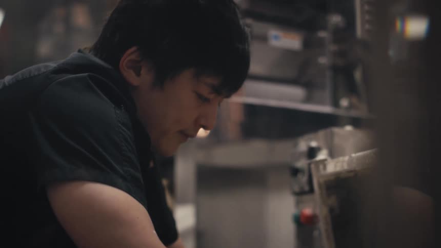 Side portrait of a man working inside a restaurant