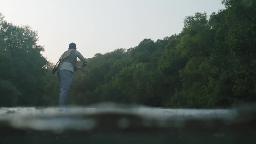 A clip of a man fishing in the river