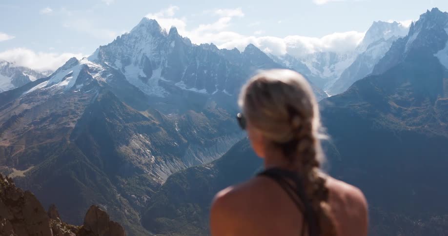 Woman looking out the mountain peaks in the distance