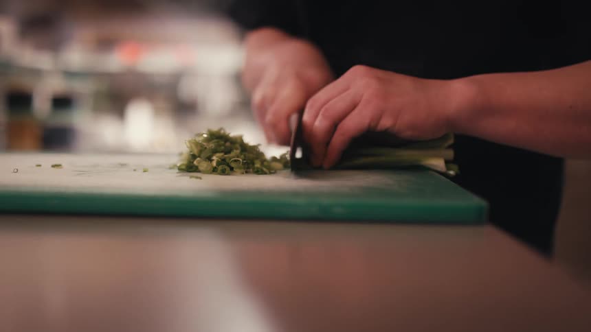 A man is chopping vegetables with a knife