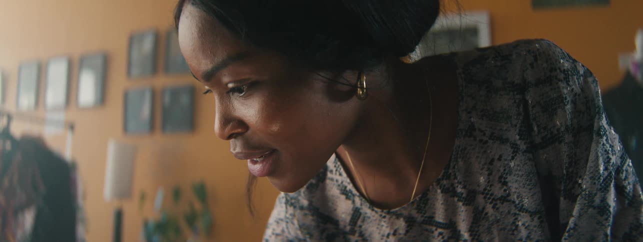 Side portrait of a woman looking focused and with a happy facial expression