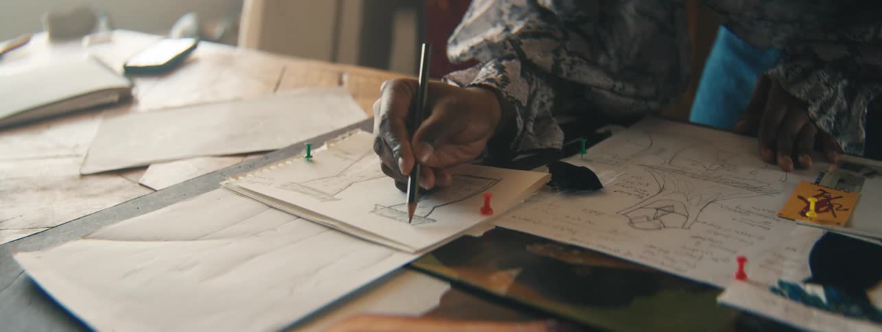 A woman is sketching on paper