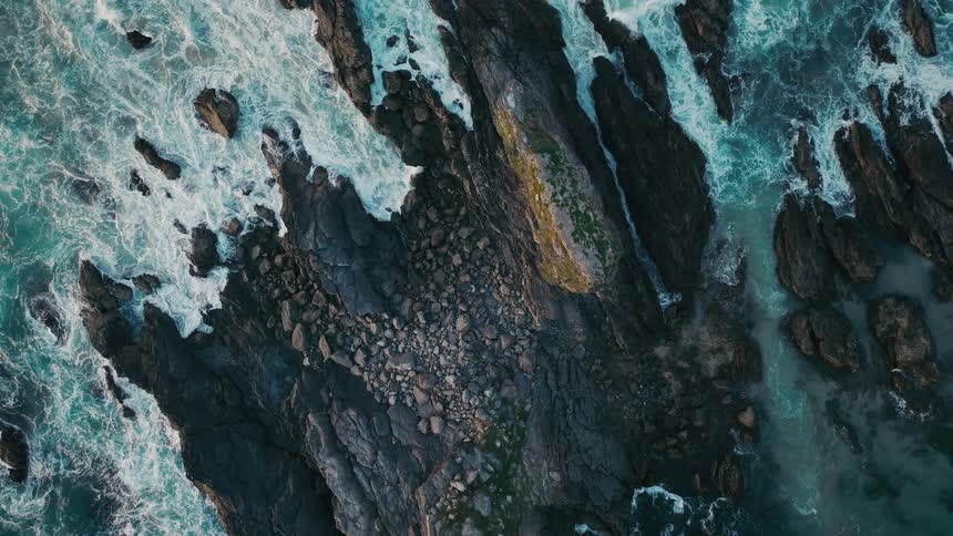 Waves crash on the rocks of the shore
