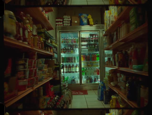 Aisle of a Bodega with food and drinks in refrigerators in the background