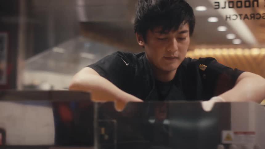 Man in a restaurant kitchen focused on cooking