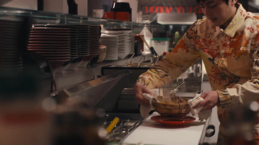 A Chef prepares food in a restaurant kitchen