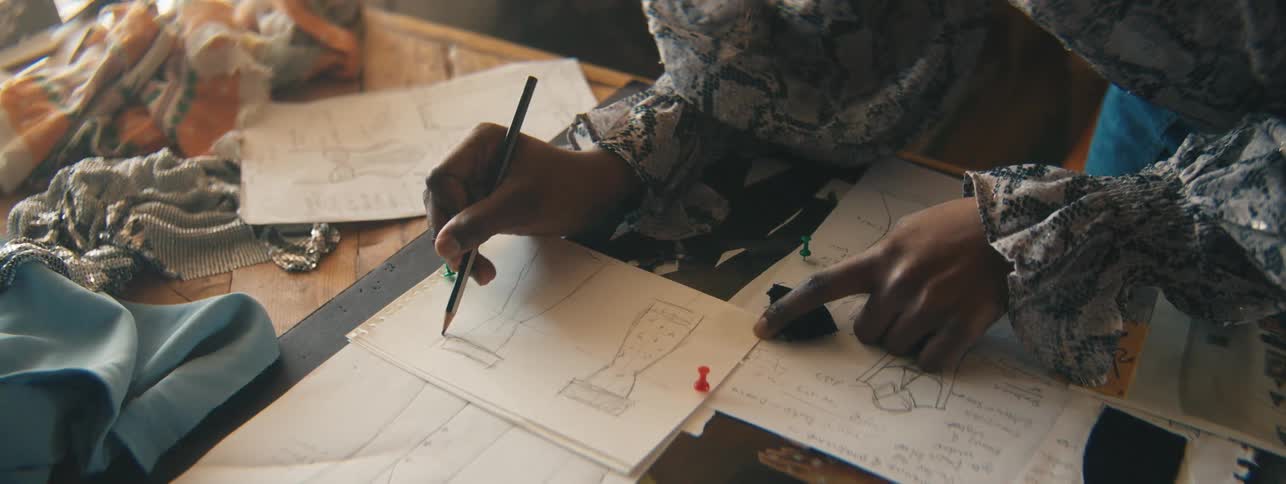 Womans hand with a pencil drawing