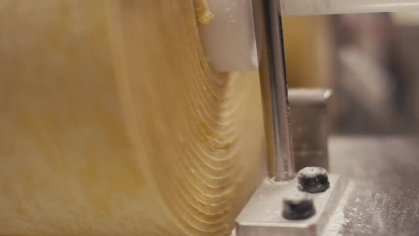 Close up of a rolling pin of pasta dough