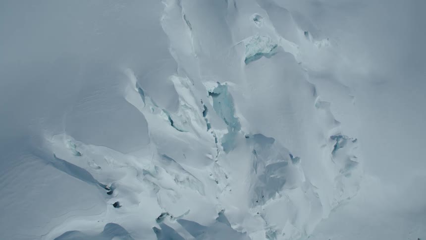Aerial panorama of snow layers with cutouts on a mountain
