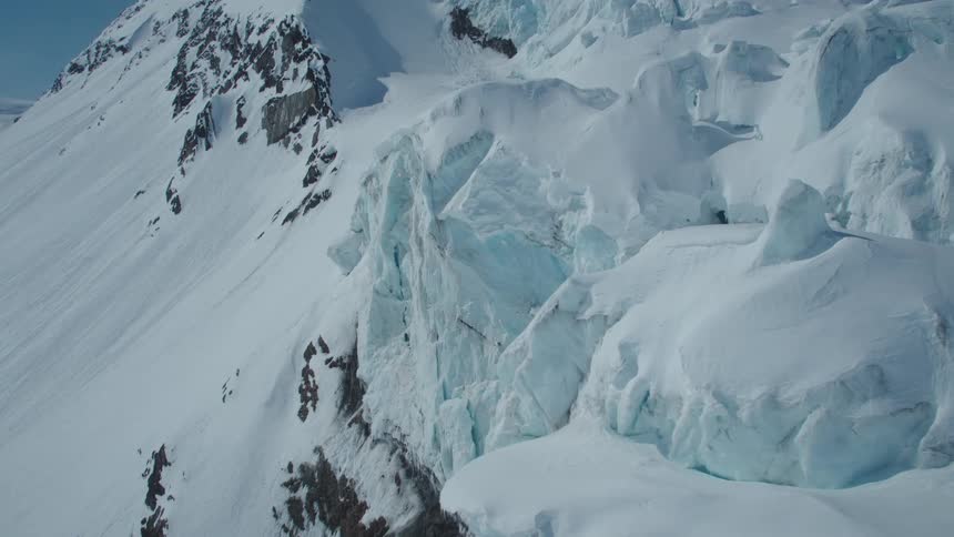 Aerial view of snow layers and mountains during daytime