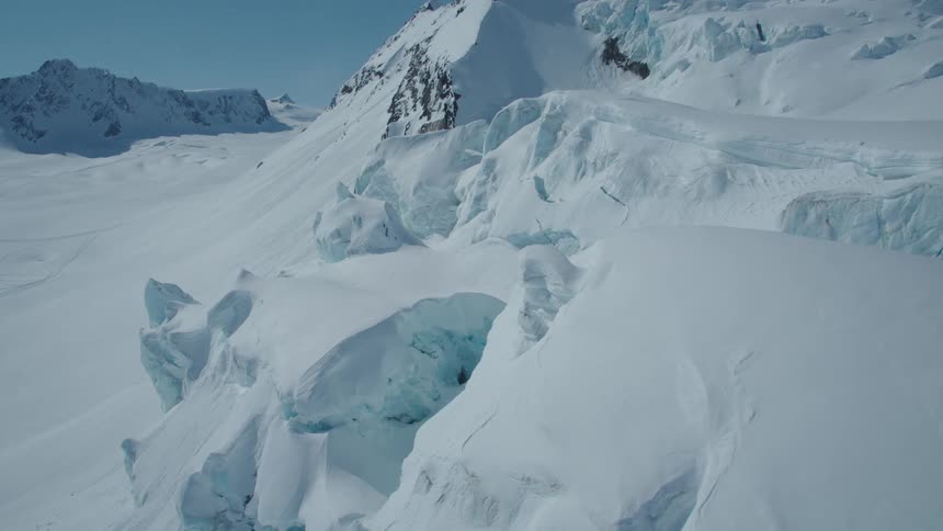 Aerial view of snow layers with deformations on mountains