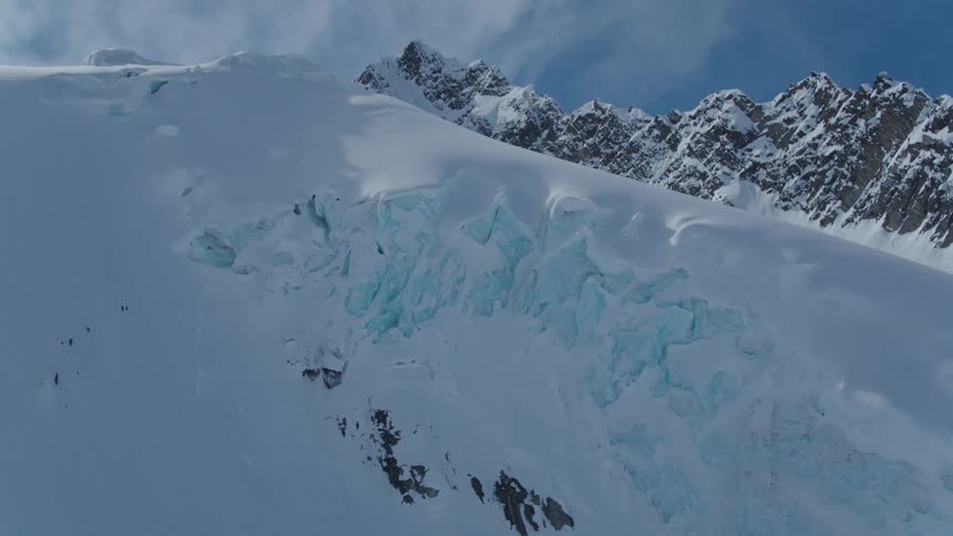 A view of a snowy mountain peak with a large glacier