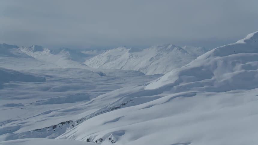 An arctic region of a mountain range covered with thick snow