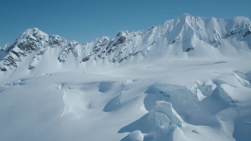 Panorama of snowcovered mountains against a clear sky