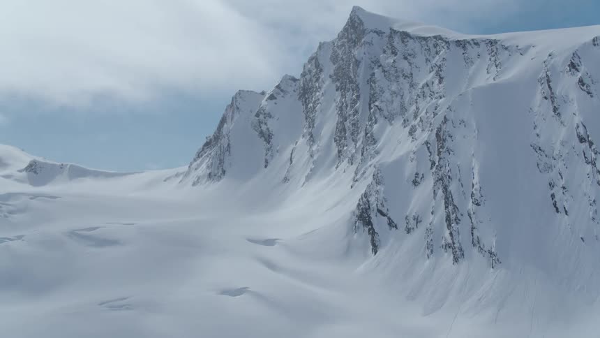A snow covered mountain peak and plateau