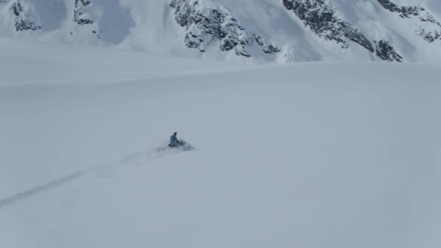 An aerial clip of a person riding through the ice