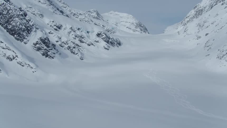 Mountain range with layers of snow on a cloudy winter day