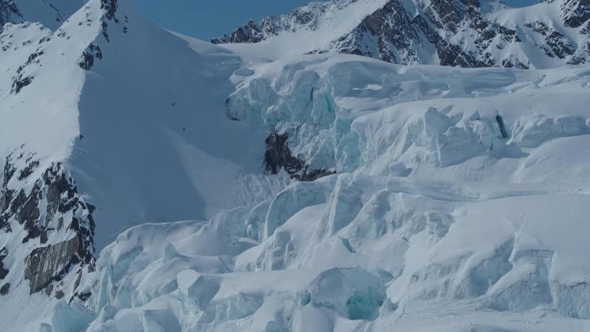 Mountain range covered by layers of snow view during the day