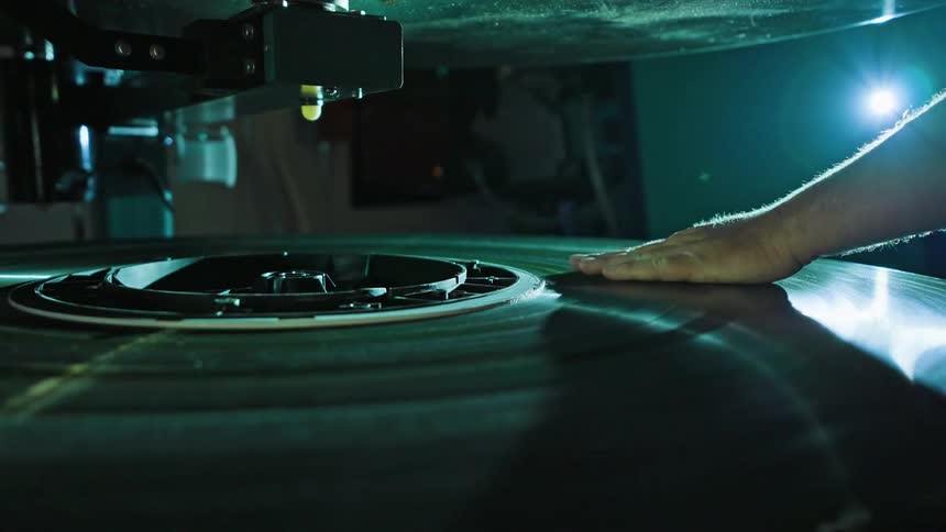 A close up clip of a persons hand rubbing on a disk player