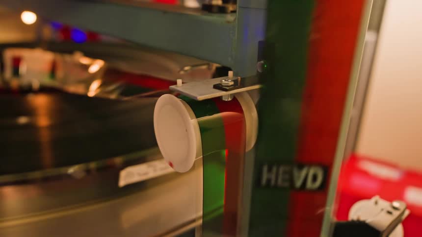 A person runs tape through the projector reel