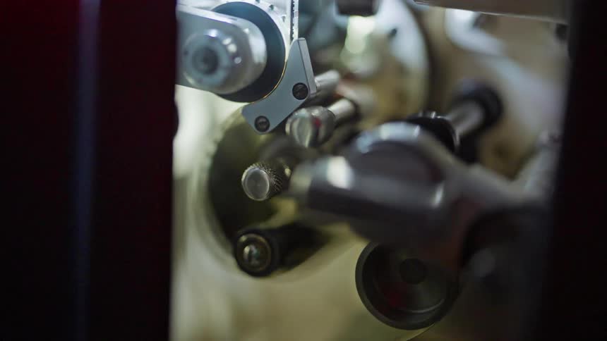 The film reel is spinning in the projector