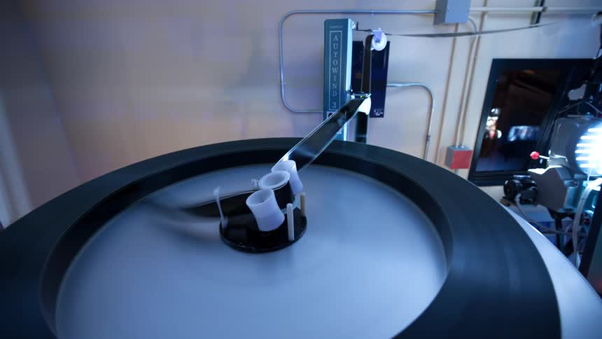 A giant machine plays a long strip of film