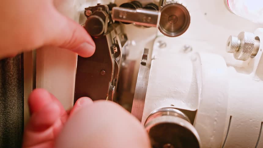 A person is assembling a projector