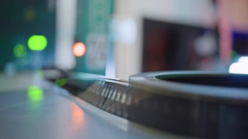 Retro film tape in motion on a reel in a machine