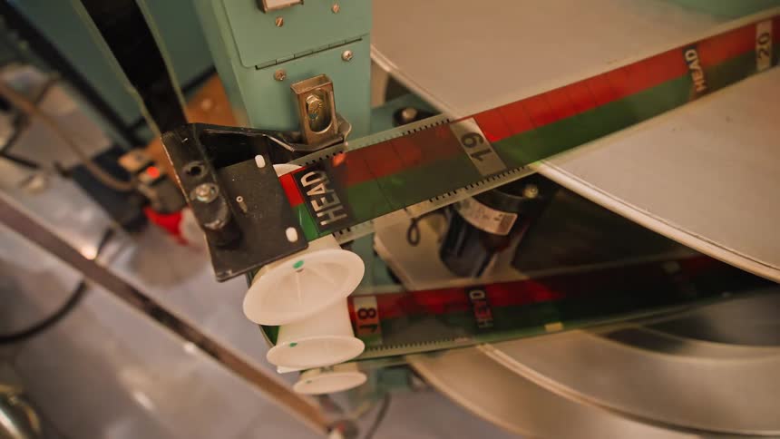 A clip of a person fixing a film tape on a player