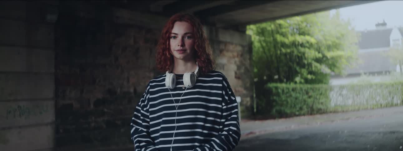 A woman is smiling outside