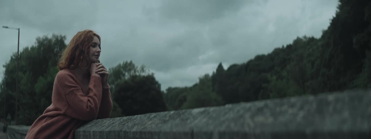 A woman looks at nature on a windy day