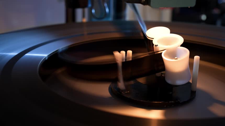 Close up of a strip of film winding through a film projector out of a reel
