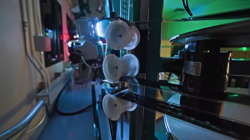 A close up of running film projector sprockets