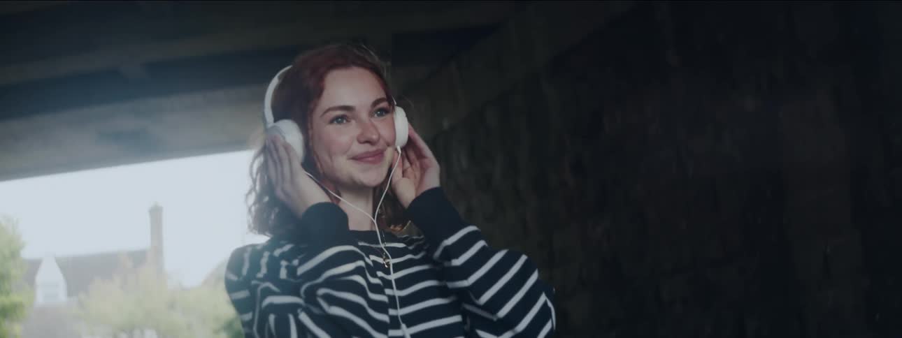 Smiling woman using headphones