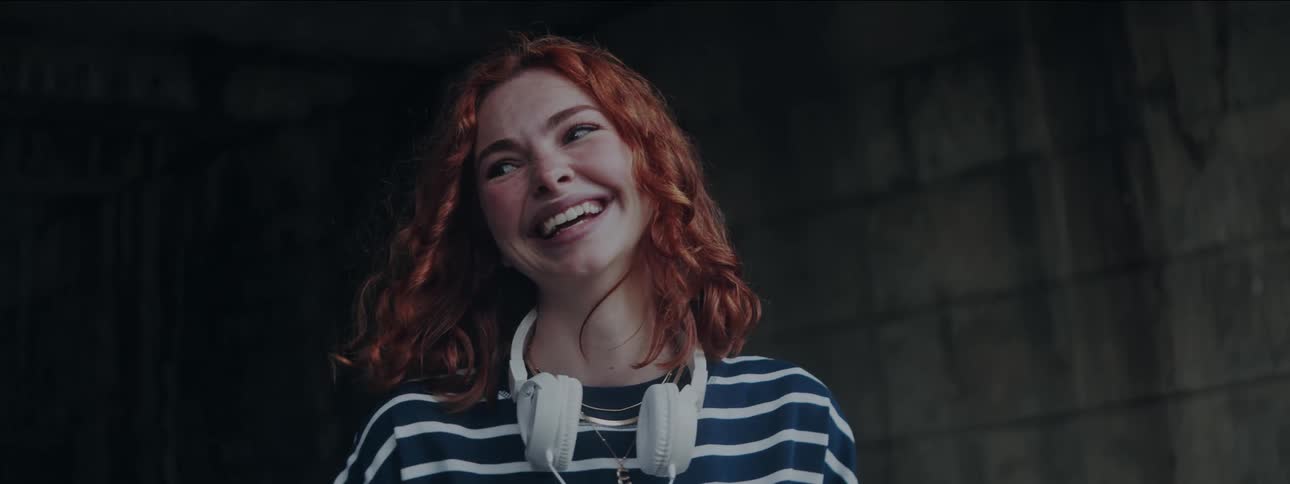 Red curly haired woman smiling