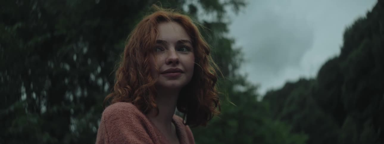 A woman is smiling outside