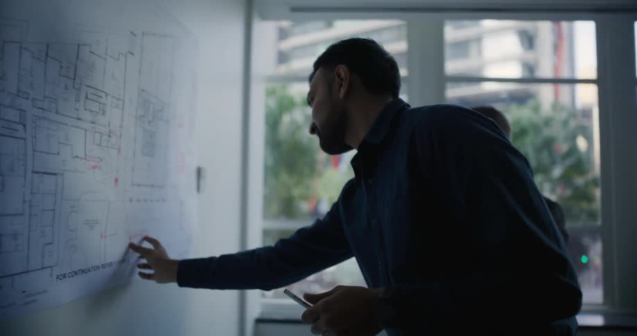 Two men in a room working on a project
