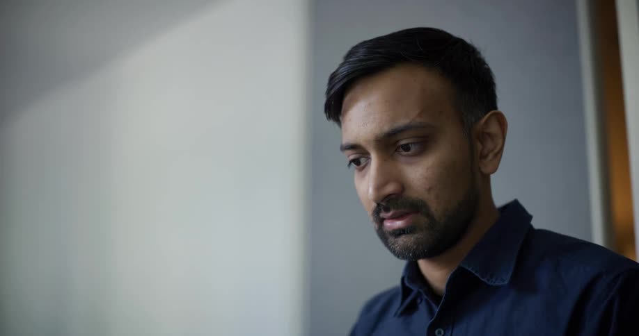 Portrait of a concentrated man receiving instructions from another person